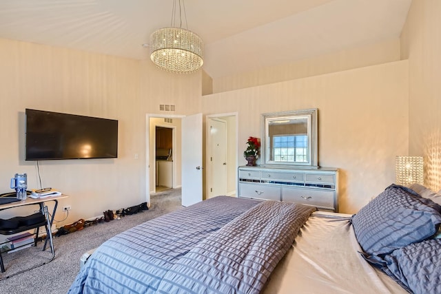 carpeted bedroom with high vaulted ceiling, visible vents, and a notable chandelier