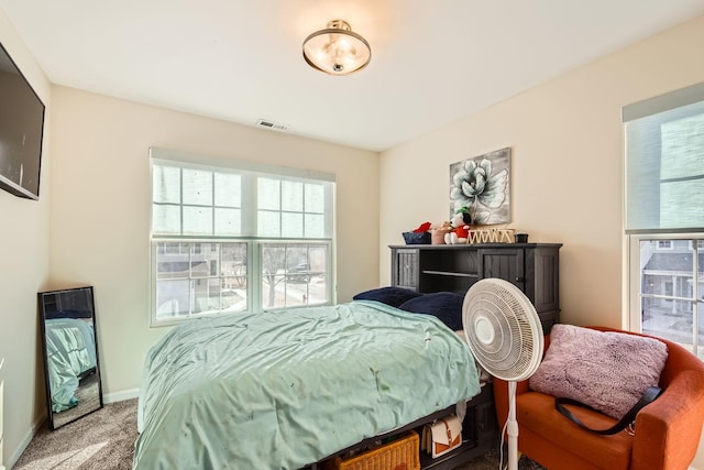 carpeted bedroom with visible vents and baseboards