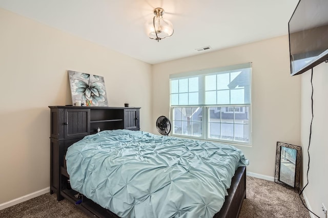 carpeted bedroom featuring visible vents and baseboards