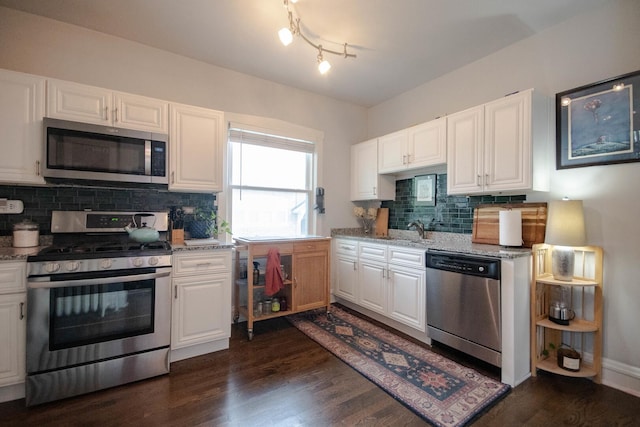 7940 S Oglesby Ave, Chicago, IL 60617 - kitchen featuring stainless steel appliances, backsplash, dark wood-style flooring, white cabinets, and light stone counters