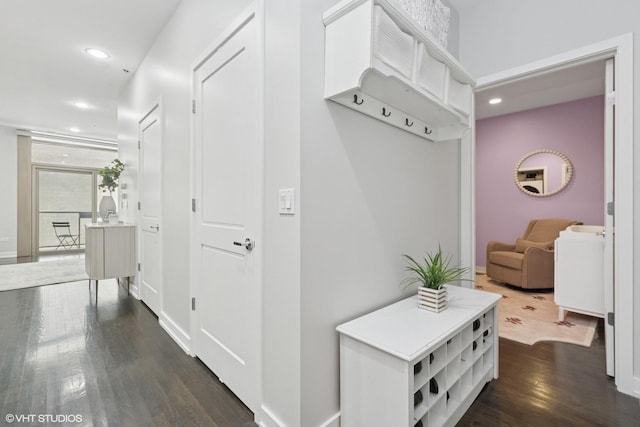 corridor with recessed lighting, dark wood-type flooring, and baseboards