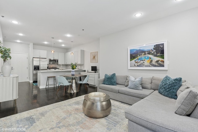 living area featuring recessed lighting and dark wood-type flooring