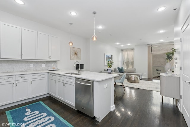 kitchen with dishwasher, a peninsula, dark wood-style floors, and a sink