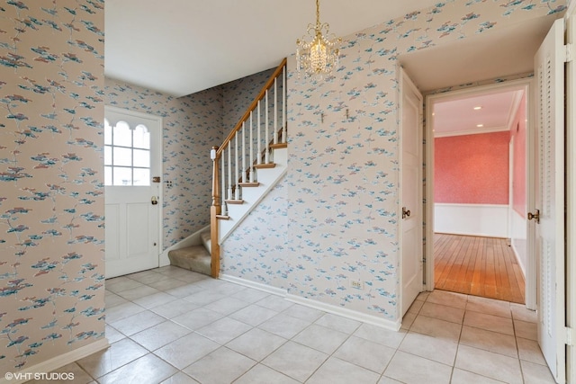 entryway with stairs, light tile patterned flooring, baseboards, and wallpapered walls