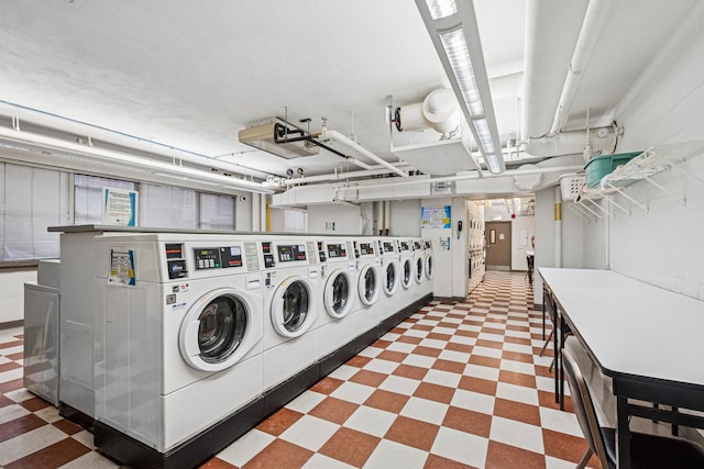 shared laundry area with independent washer and dryer and tile patterned floors