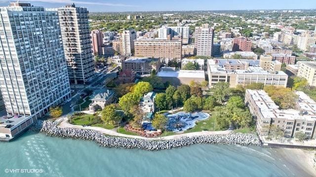 drone / aerial view featuring a view of city and a water view