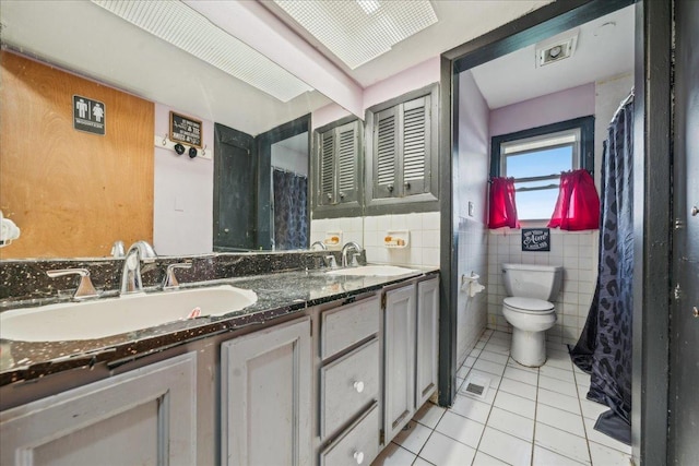 9 Forest Ln, Elk Grove Village, IL 60007 - bathroom with tile patterned floors, tile walls, a sink, and toilet