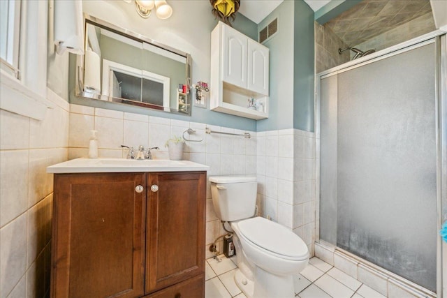 9 Forest Ln, Elk Grove Village, IL 60007 - bathroom featuring tile patterned flooring, toilet, a shower stall, visible vents, and tile walls