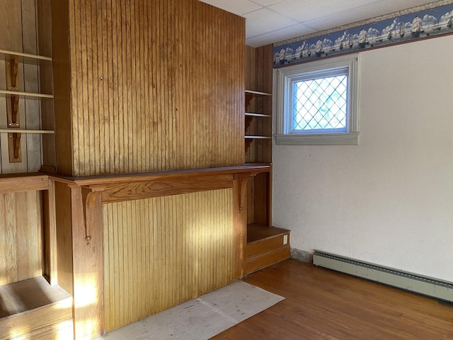 unfurnished room featuring a baseboard radiator and wood finished floors