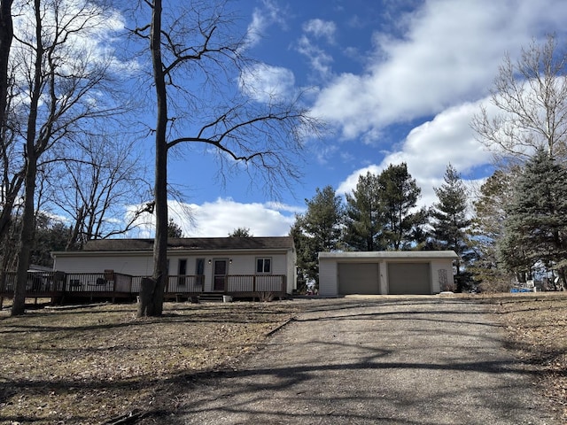 view of front of home with a wooden deck and an outdoor structure