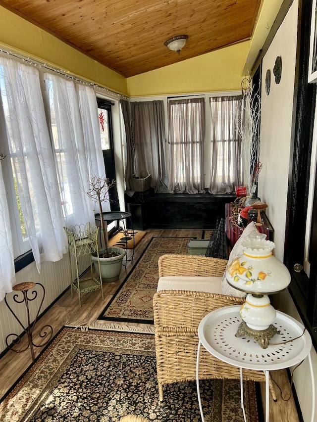 sunroom with lofted ceiling and wood ceiling