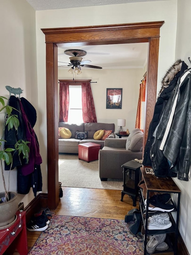 living area featuring ceiling fan and wood finished floors