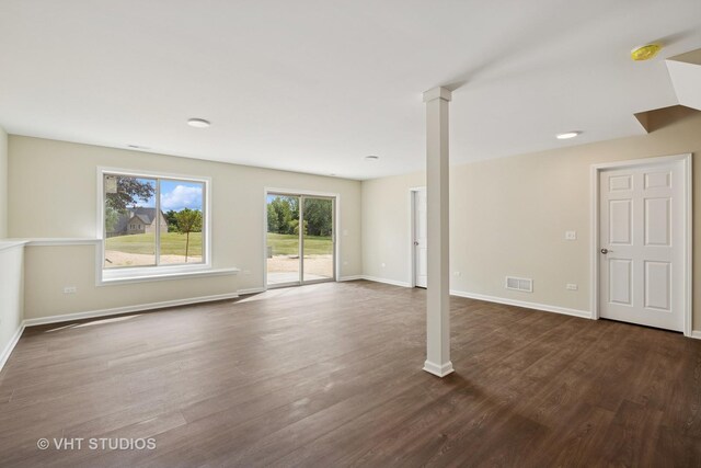 5912 Prairie Ridge Rd, Crystal Lake, IL 60014 - unfurnished living room featuring dark wood-type flooring and ornate columns
