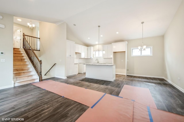 5912 Prairie Ridge Rd, Crystal Lake, IL 60014 - kitchen with a chandelier, dark wood-style flooring, white cabinetry, an island with sink, and hanging light fixtures