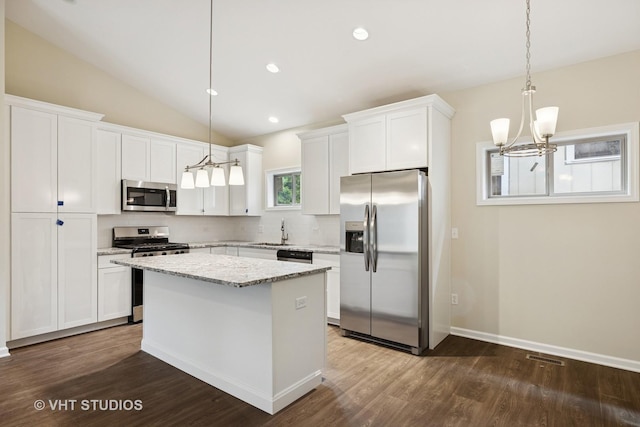 5912 Prairie Ridge Rd, Crystal Lake, IL 60014 - kitchen with appliances with stainless steel finishes, a chandelier, decorative backsplash, a center island, and dark wood-style flooring