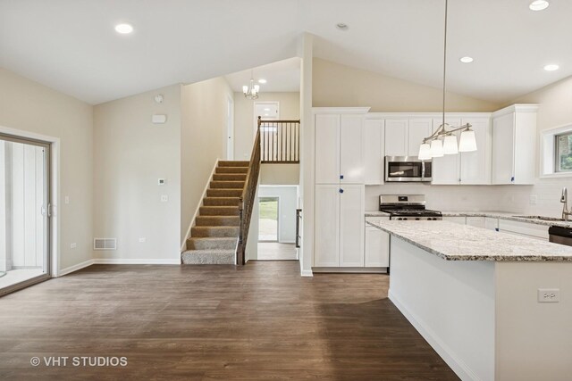 5912 Prairie Ridge Rd, Crystal Lake, IL 60014 - kitchen with appliances with stainless steel finishes, dark wood-type flooring, white cabinetry, lofted ceiling, and light stone countertops