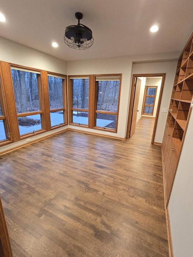 unfurnished room with baseboards, wood finished floors, and recessed lighting