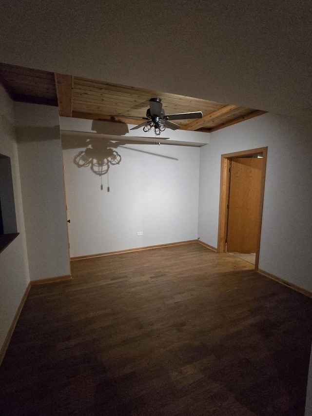 empty room with ceiling fan, baseboards, and wood finished floors