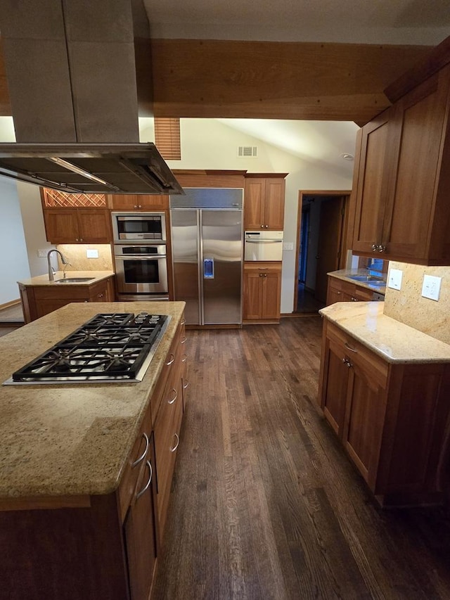 kitchen with built in appliances, lofted ceiling with beams, dark wood-style flooring, visible vents, and island exhaust hood