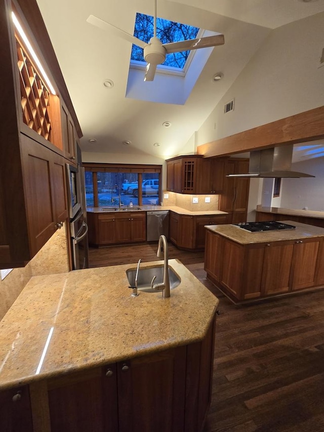 kitchen featuring visible vents, light stone counters, dark wood-type flooring, stainless steel appliances, and a sink