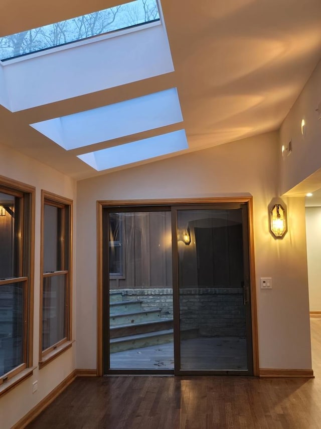 interior space featuring a skylight and baseboards