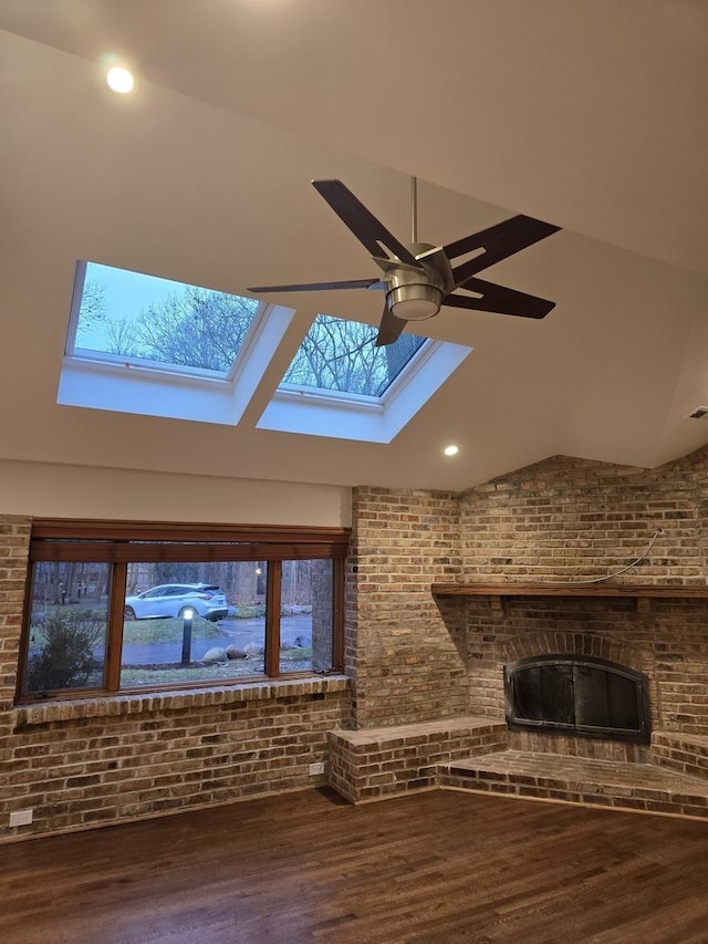 unfurnished living room featuring ceiling fan, brick wall, wood finished floors, and recessed lighting