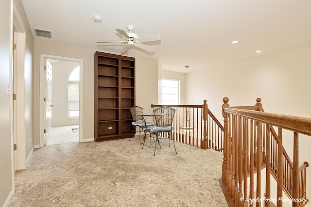 living area with visible vents, baseboards, ceiling fan, an upstairs landing, and recessed lighting