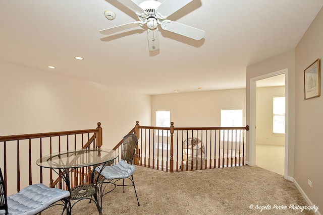 living area with carpet floors, an upstairs landing, and recessed lighting