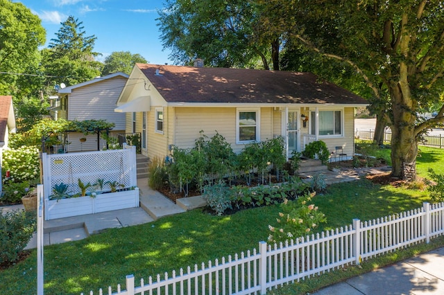 view of front of home with a fenced front yard and a front yard