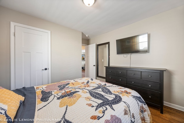 bedroom featuring baseboards and wood finished floors