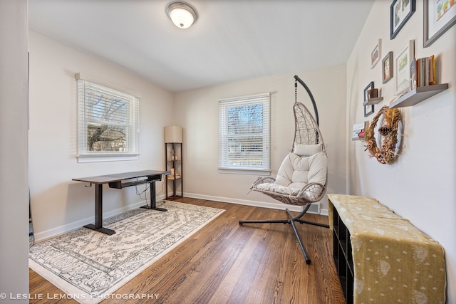 living area featuring baseboards and wood finished floors