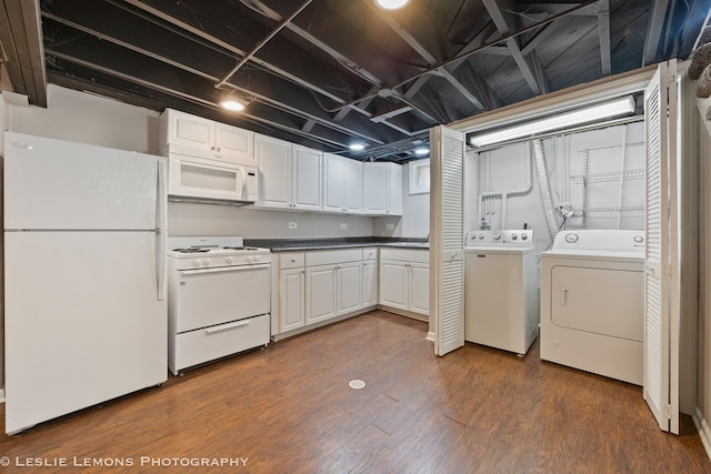 washroom featuring dark wood-style flooring, washer and clothes dryer, and laundry area