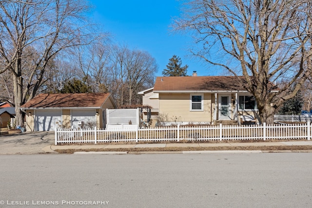 ranch-style home featuring a fenced front yard, driveway, and a chimney