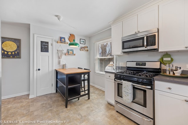 kitchen with stainless steel appliances, white cabinets, baseboards, and open shelves