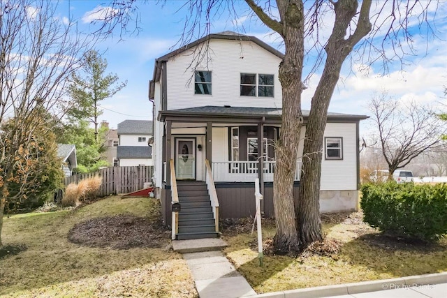 view of front of home with fence and covered porch