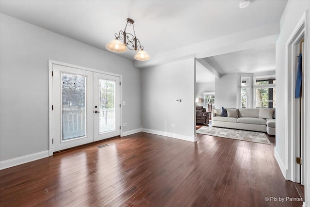 interior space featuring dark wood-style floors, french doors, visible vents, and baseboards