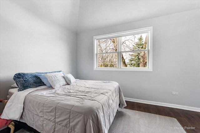 bedroom featuring wood finished floors and baseboards