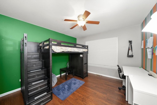 bedroom featuring visible vents, baseboards, ceiling fan, and wood finished floors