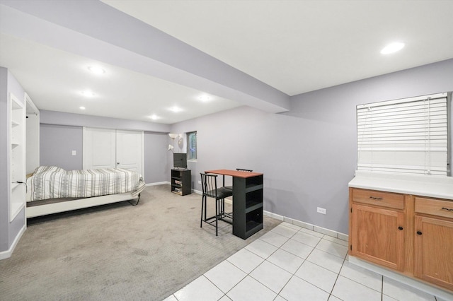 bedroom with baseboards, recessed lighting, light tile patterned floors, and light colored carpet
