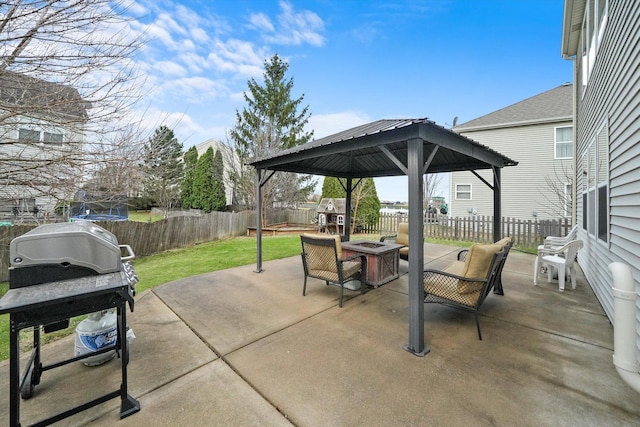 view of patio / terrace with a fenced backyard, an outdoor fire pit, a gazebo, and a grill