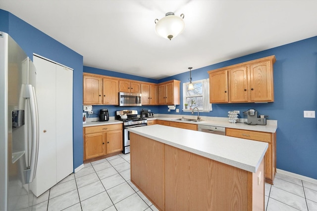 kitchen featuring pendant lighting, light countertops, a sink, and appliances with stainless steel finishes