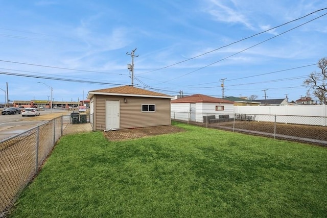 view of yard featuring an outbuilding and a fenced backyard