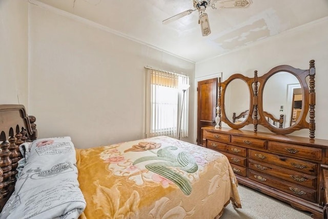 bedroom with carpet floors, a ceiling fan, and crown molding