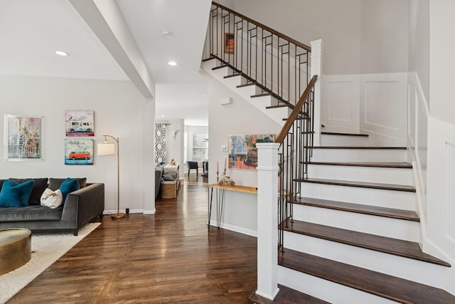 stairs featuring baseboards, wood finished floors, and recessed lighting