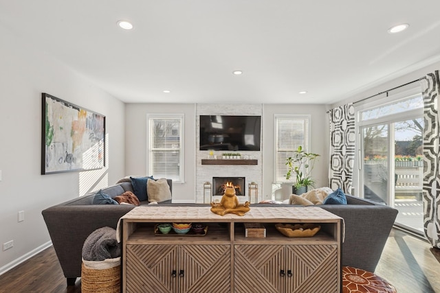 living room with a fireplace, baseboards, dark wood-type flooring, and recessed lighting