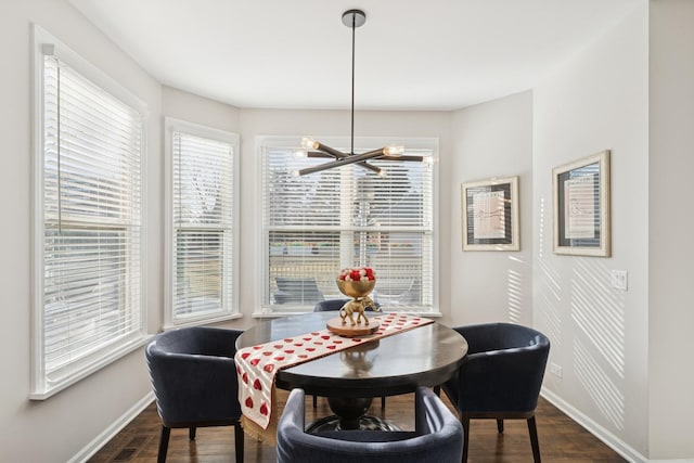 dining area with a notable chandelier, visible vents, baseboards, and dark wood-type flooring