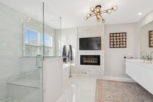 bathroom with baseboards, a freestanding bath, visible vents, and a marble finish shower