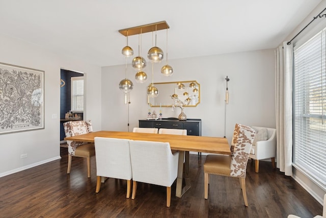 dining room with dark wood-type flooring and baseboards