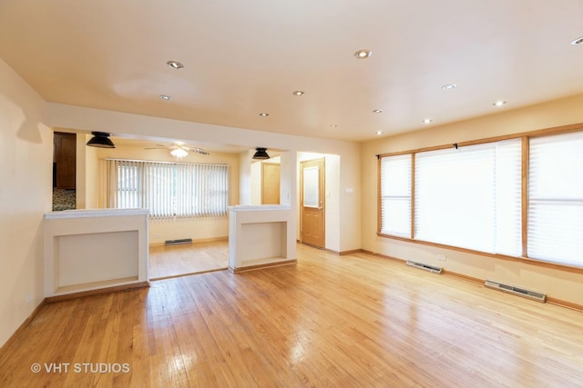 unfurnished living room featuring recessed lighting, baseboards, visible vents, and light wood finished floors