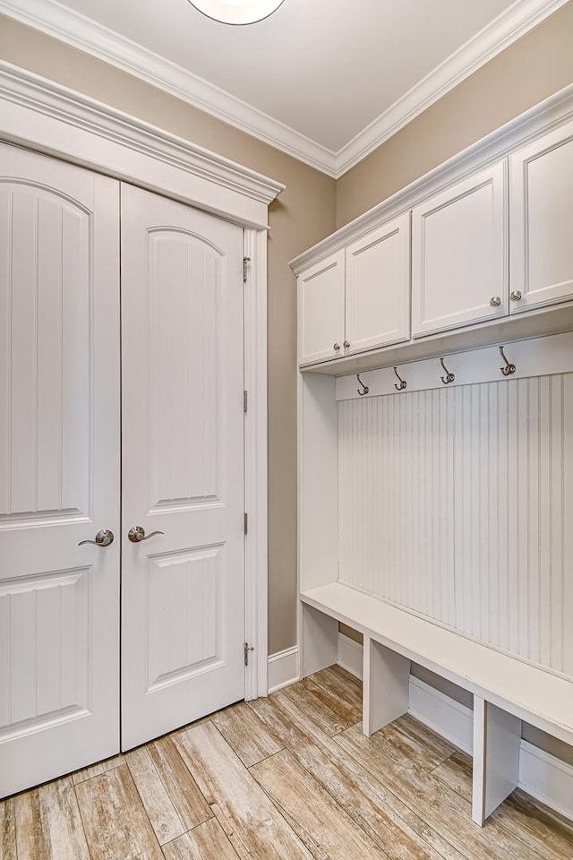 mudroom with crown molding and light wood-type flooring